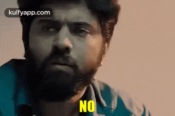 a man with a beard is making a funny face and saying `` no '' .