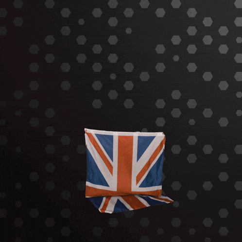 a british flag hangs on a black wall