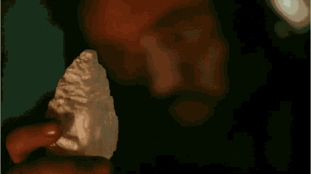 a man with a beard is looking at another man 's face .