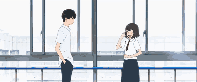 a man and woman holding hands over a blue railing