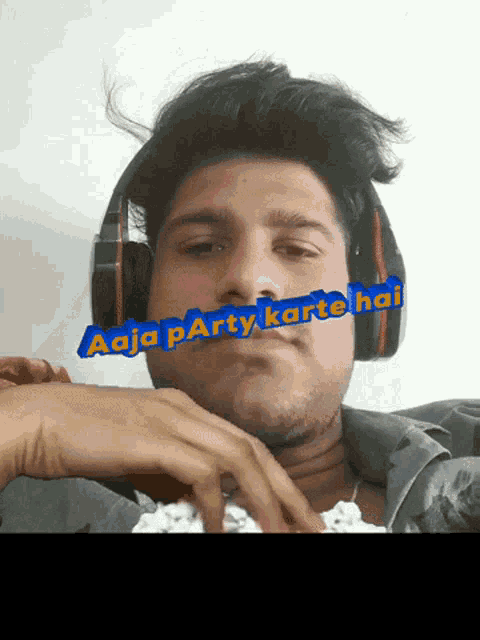 a man wearing headphones with the words aaja party karte hai above his face