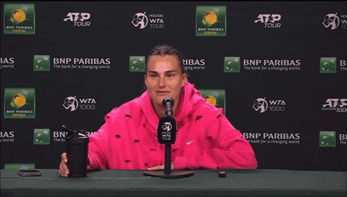 a woman stretches her leg in front of a bnp paribas ad