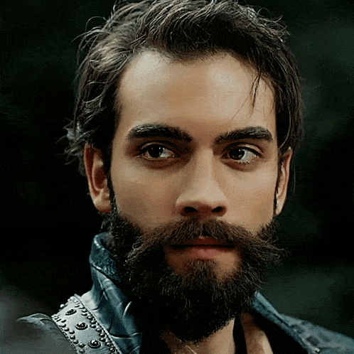 a man with a beard and mustache is wearing a blue leather jacket