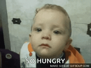 a baby is making a funny face with the words `` so hungry '' written on it .