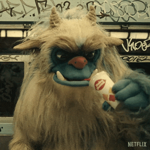 a stuffed animal with horns is holding a potato chip and says netflix