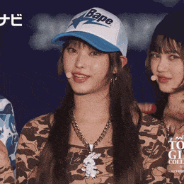 a woman wearing a bape hat and a necklace