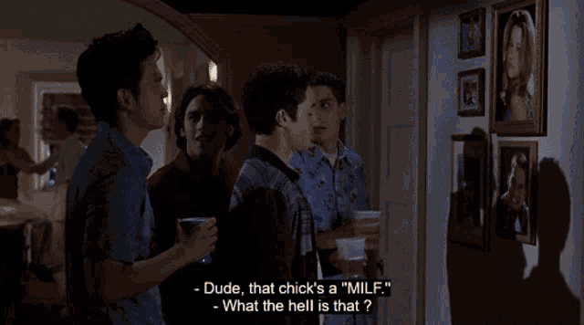 a group of men are standing in a living room and one of them says " dude that chick 's a " milf