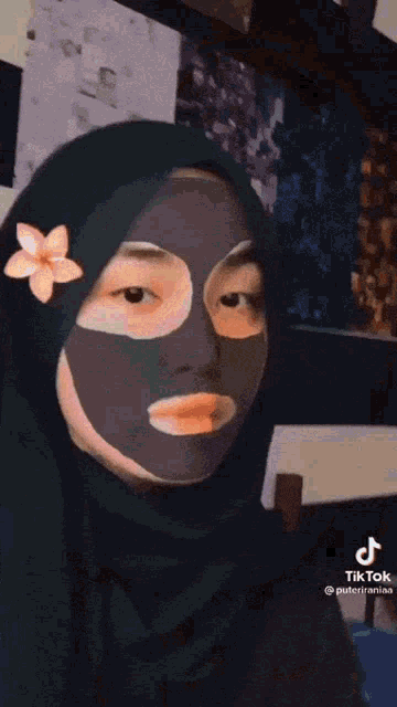 a woman wearing a purple hijab has a tiktok account