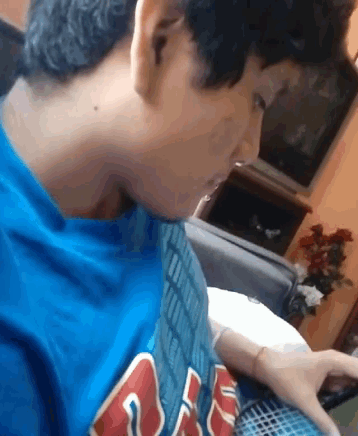 a boy wearing a blue shirt that says ' aa ' on it