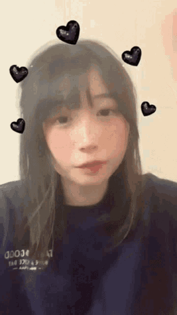 a girl with hearts around her head and a shirt that says dojo