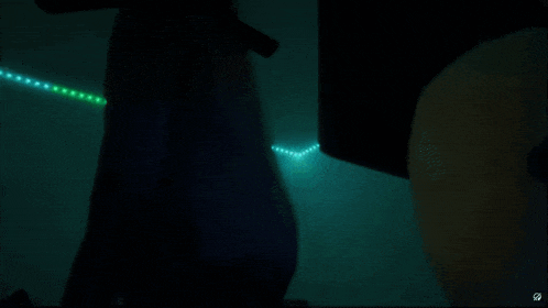 a dark room with a few lights on the floor