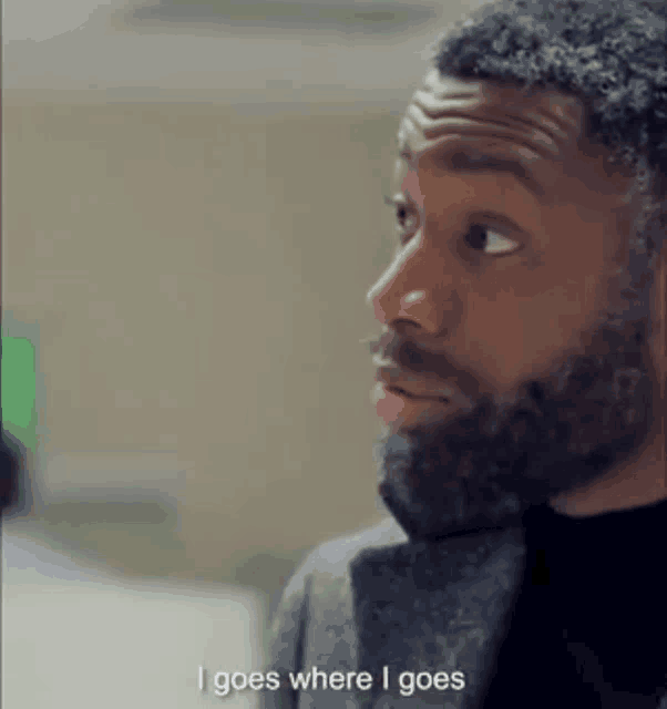 a man with a beard says " i goes where i goes " in a video