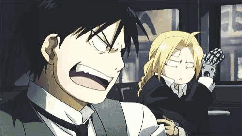 a man and a woman are sitting in a car and one of them is making a funny face