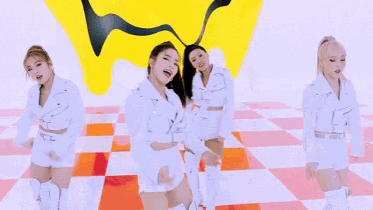 three women in white jackets are dancing in front of a yellow smiley face