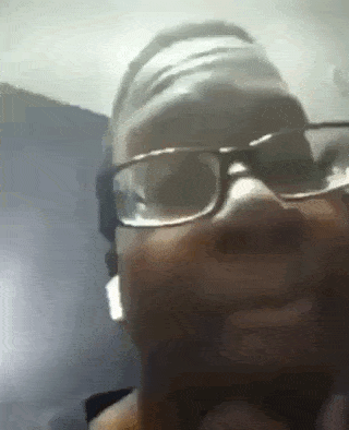 a man wearing glasses and a headband is looking at the camera .