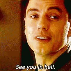 a close up of a man 's face with the words see you in hell below it