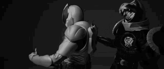 a black and white photo of two action figures standing next to each other