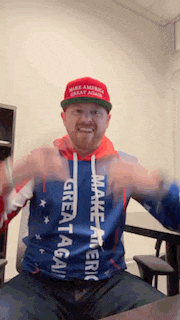 a man wearing a make america great again hat and a make america great again hoodie