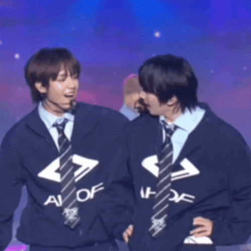 two boys wearing matching jackets and ties with the letters a and o on them