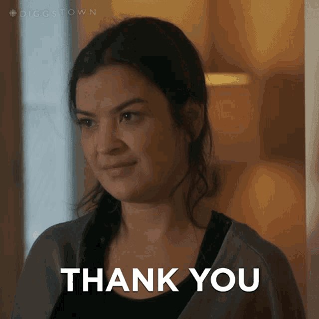 a woman says thank you in front of a door