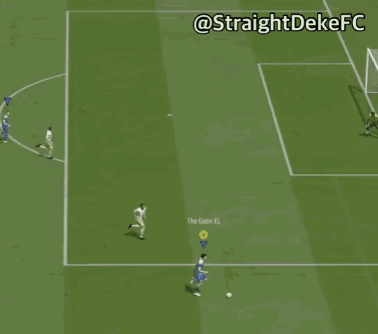 a soccer game is being played on a green field and the goal is marked with a yellow circle