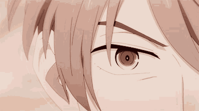 a close up of a person 's eye with a slight smirk on his face