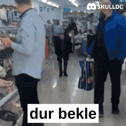 a man in a blue jacket holds a blue bag in a store with skulldc written on the bottom right