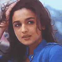 a close up of a woman 's face with her hand on her hair .