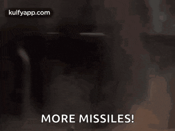 a man is holding a rocket launcher with the words `` more missiles '' written on it .