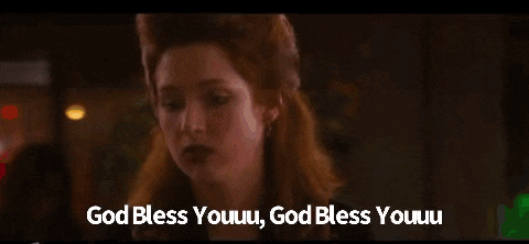 a woman in a plaid shirt is crying and says god bless youuu