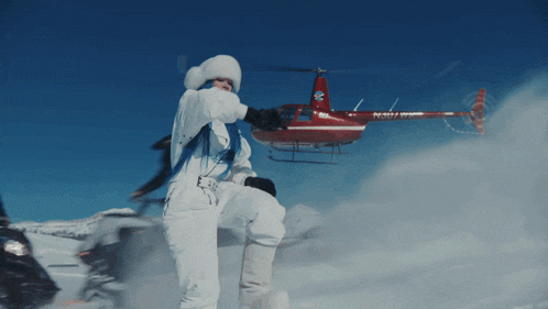 a red and white helicopter with the letters n301vm on it
