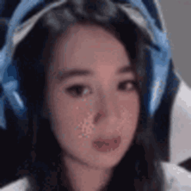 a close up of a woman wearing headphones and a headband .