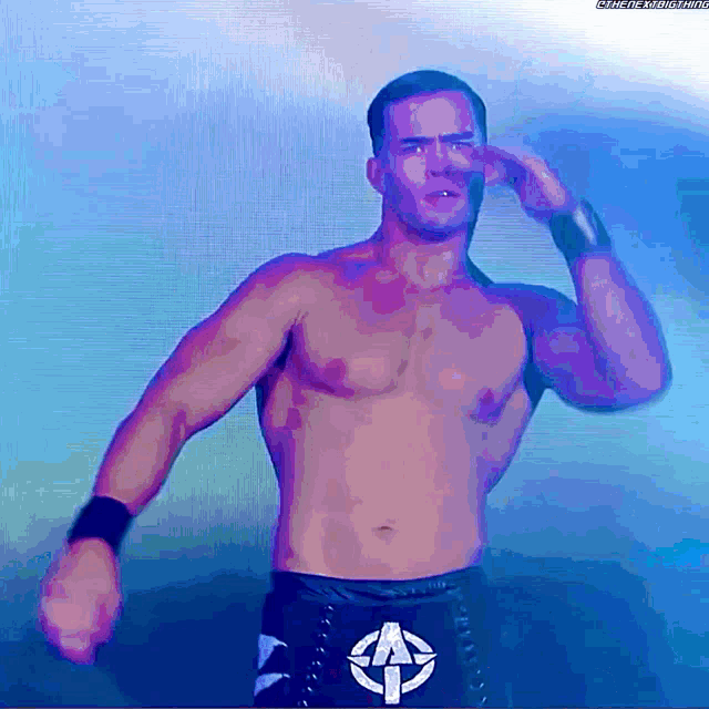 a man without a shirt is wearing a belt with the letter a on the front