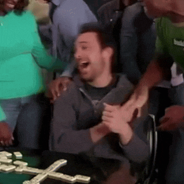 a man in a wheelchair is playing dominoes with his friends