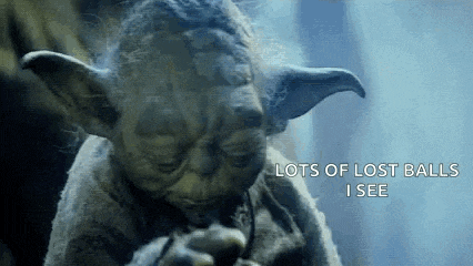 a close up of a statue of yoda with the words `` lots of lost balls i see '' .