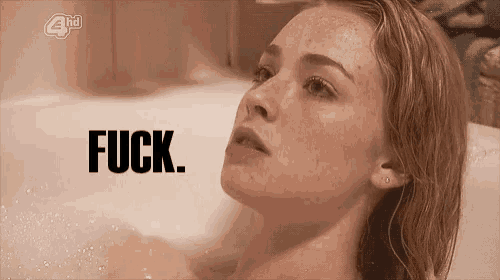 a woman is taking a bath in a bathtub with the words `` fuck '' written above her .