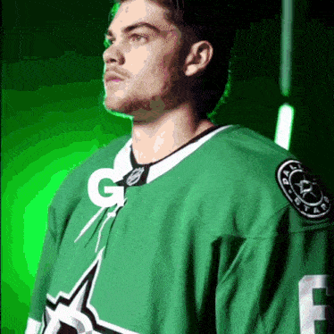a man in a green jersey with the letter g on the front