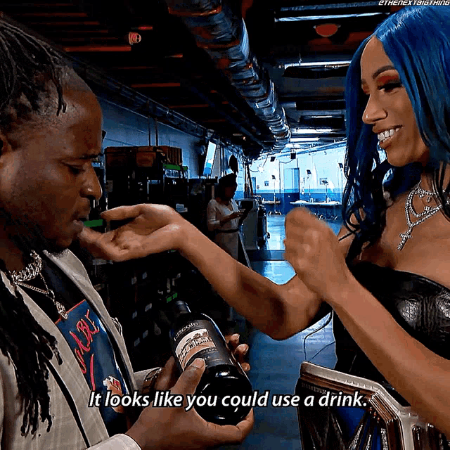 a woman with blue hair says it looks like you could use a drink while holding a bottle of wine