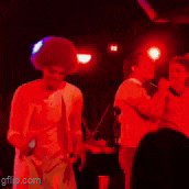 a group of people are dancing in a dark room with a gif.com watermark on the bottom