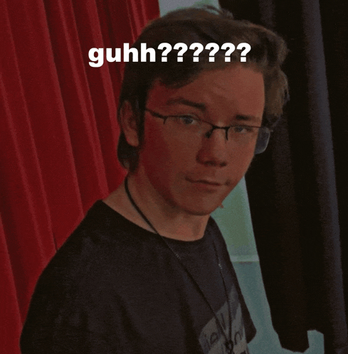 a man wearing glasses and a black shirt with the words guhh on his face