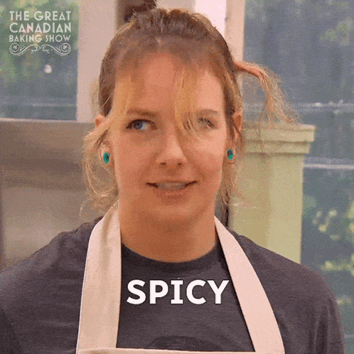 a woman wearing an apron and a shirt that says spicy on it