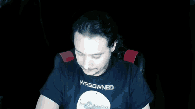 a man wearing a black t-shirt that says wasdwned