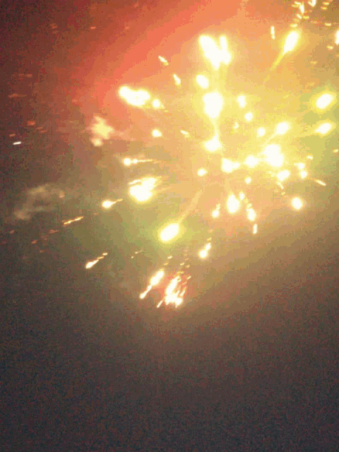 fireworks exploding in the night sky with a red background
