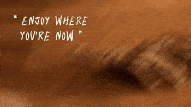 a skeleton hand is laying in the dirt with the words enjoy where you 're now