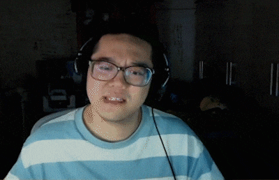 a man wearing glasses and headphones looks very sad