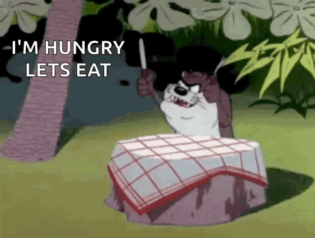 a cartoon character is sitting at a table holding a knife and says " i 'm hungry lets eat "