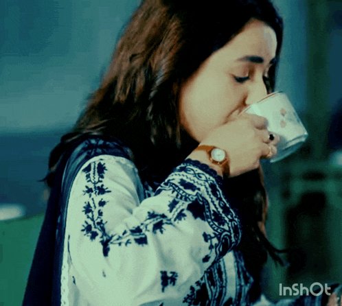 a woman drinking from a cup with inshot on the bottom right