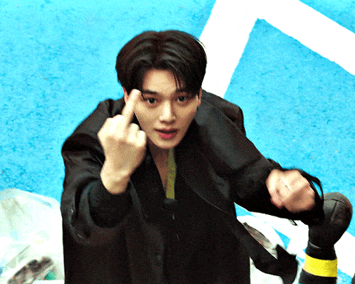 a man giving the middle finger while wearing a black jacket