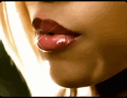 a close up of a woman 's mouth with red lipstick