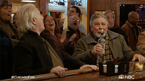 a group of people sitting at a bar with the hashtag #chicagofire in the corner